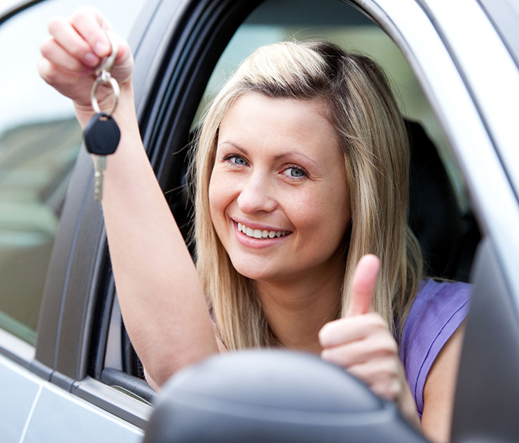 An image of a young lady that has just passed her driving text